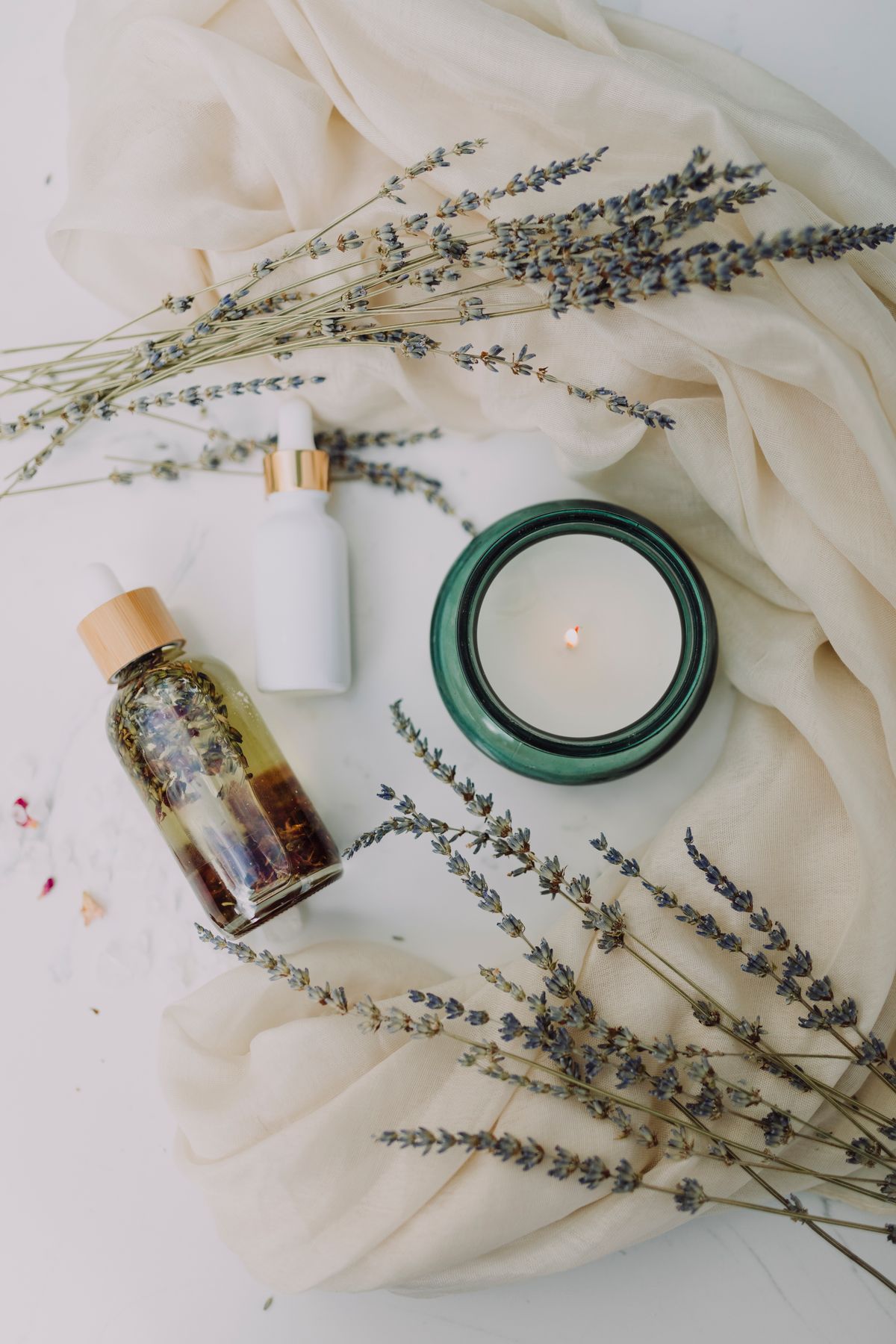Calming spa atmosphere with candle and botanicals